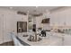 Bright kitchen features white cabinets, stainless steel appliances, and a large island with counter seating at 29837 Imperati Blvd, Wesley Chapel, FL 33543