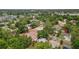 An aerial view shows proximity to tennis courts, park and other community features and tree lined streets at 3119 W North St, Tampa, FL 33614