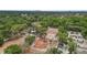 The aerial view includes residences, park/playground, tennis courts, and lush trees, near Tampa, Florida at 3119 W North St, Tampa, FL 33614