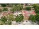 The aerial view features a park, basketball court, tennis court, lush trees, and ample parking space at 3119 W North St, Tampa, FL 33614