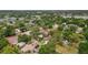 Wide aerial shot shows a home in a neighborhood with many trees near recreational areas at 3119 W North St, Tampa, FL 33614