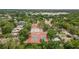 An aerial view showcases a tennis court and other amenities near the residences and a nearby lake at 3119 W North St, Tampa, FL 33614