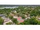 Overhead view displaying residences, a lake, tennis courts, and park within a community with lush, mature trees at 3119 W North St, Tampa, FL 33614