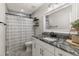 Well-lit bathroom featuring granite countertops, a modern vanity, and a shower-tub combo at 3119 W North St, Tampa, FL 33614