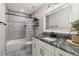 Bright bathroom features granite countertops, sleek vanity, and tiled shower with tub at 3119 W North St, Tampa, FL 33614