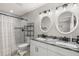Bathroom features dual sinks, granite counters, tiled floors and a tiled shower at 3119 W North St, Tampa, FL 33614