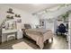 Bedroom decorated with vines, full sized bed, workspace and vanity with a large mirror at 3119 W North St, Tampa, FL 33614