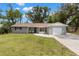 Charming single-story home with a brick facade, well-maintained lawn, and attached one car garage at 3119 W North St, Tampa, FL 33614