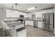 Modern kitchen featuring stainless steel appliances, grey marble counter tops, and white cabinetry at 3119 W North St, Tampa, FL 33614