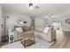 Inviting living room featuring modern lighting, sleek floors, and a comfortable sectional sofa with a round wood coffee table at 3119 W North St, Tampa, FL 33614