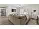 Bright living room featuring a sectional sofa, sleek floors, and a large front window for lots of natural light at 3119 W North St, Tampa, FL 33614