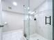 Contemporary bathroom with glass-enclosed shower, marble floors, and updated fixtures at 3213 E Genesee St, Tampa, FL 33610
