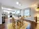 Open dining area with hardwood floors, a view into the kitchen, and ample natural light at 3213 E Genesee St, Tampa, FL 33610
