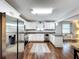 Modern kitchen with stainless steel appliances, granite countertops, white cabinets, and hardwood floors at 3213 E Genesee St, Tampa, FL 33610