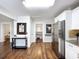 Open-concept living space featuring hardwood floors, modern appliances, and stylish decor at 3213 E Genesee St, Tampa, FL 33610
