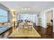 Open concept living and dining area with a bright rug, hardwood floors, and lots of natural light at 3213 E Genesee St, Tampa, FL 33610