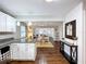 Open concept home with kitchen view of dining and living rooms with hardwood flooring, light and airy space at 3213 E Genesee St, Tampa, FL 33610