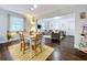 Open concept living and dining area with hardwood floors and a bright, airy feel with large windows at 3213 E Genesee St, Tampa, FL 33610