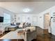 Comfortable living room with a sectional sofa, hardwood floors, and easy access to other areas of the home at 3213 E Genesee St, Tampa, FL 33610