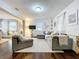 Open-concept living room featuring a large sectional sofa, hardwood floors, and natural light at 3213 E Genesee St, Tampa, FL 33610