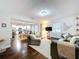 Bright living room with hardwood floors, comfortable seating, and an open layout flowing into the kitchen at 3213 E Genesee St, Tampa, FL 33610