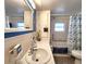 Bathroom features blue accents, nautical decor, vanity, sink, and bathtub shower combo at 34483 Cactus N Dr, Pinellas Park, FL 33781