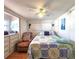 Cozy bedroom features a bed with a sea-themed quilt, chair, and storage cabinet at 34483 Cactus N Dr, Pinellas Park, FL 33781