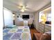 Bedroom featuring a bed with a sea-themed quilt, TV, and storage cabinets at 34483 Cactus N Dr, Pinellas Park, FL 33781
