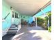 Spacious carport featuring outdoor seating and ample room for parking and leisure, ideal for relaxed living at 34483 Cactus N Dr, Pinellas Park, FL 33781
