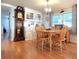 Charming dining area featuring wood floors, classic built-in cabinet, and stylish chandelier at 34483 Cactus N Dr, Pinellas Park, FL 33781