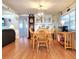 Dining area with wood flooring, decorative built-in cabinet, and adjacent living space at 34483 Cactus N Dr, Pinellas Park, FL 33781