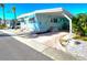Inviting mobile home with a covered carport, lush landscaping, and a cozy, welcoming exterior at 34483 Cactus N Dr, Pinellas Park, FL 33781