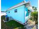 Aqua home featuring a well-maintained exterior with tidy landscaping, enhancing its curb appeal at 34483 Cactus N Dr, Pinellas Park, FL 33781