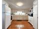 Spacious kitchen with white cabinets, wood floors, and modern appliances at 34483 Cactus N Dr, Pinellas Park, FL 33781