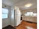Classic kitchen featuring bright white cabinets, wood floors, and access to the exterior at 34483 Cactus N Dr, Pinellas Park, FL 33781