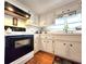 Close-up of the kitchen area showcasing appliances, cabinetry, and tile backsplash at 34483 Cactus N Dr, Pinellas Park, FL 33781