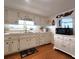 Well-lit kitchen featuring a range of appliances, ample counter space and white cabinetry at 34483 Cactus N Dr, Pinellas Park, FL 33781