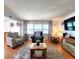 Cozy living room featuring hardwood floors, comfortable seating, and a relaxing ambiance for unwinding at 34483 Cactus N Dr, Pinellas Park, FL 33781