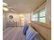 Bright main bedroom showcasing the bed, neutral decor, and access to the bathroom at 34483 Cactus N Dr, Pinellas Park, FL 33781