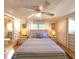 Cozy bedroom featuring stylish bedding, matching nightstands, and easy bathroom access at 34483 Cactus N Dr, Pinellas Park, FL 33781