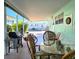 Covered patio with outdoor seating area, table, grill, and view of neighboring homes at 34483 Cactus N Dr, Pinellas Park, FL 33781