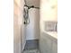 Walk-in shower featuring gray pebble floor, hand shower, and shower caddy at 34483 Cactus N Dr, Pinellas Park, FL 33781