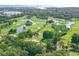 Aerial view of the lush golf course community with ponds, trees, and fairways at 36750 Us 19 N Hwy # 3104, Palm Harbor, FL 34684