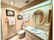Bathroom features a vanity, a mirror, a toilet, and ample lighting at 36750 Us 19 N Hwy # 3104, Palm Harbor, FL 34684