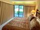 Well-lit bedroom featuring a sliding door to the outside, with carpet and view of the outdoors at 36750 Us 19 N Hwy # 3104, Palm Harbor, FL 34684