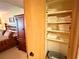 Bedroom closet with wooden door, offering ample storage space for linens and other household items at 36750 Us 19 N Hwy # 3104, Palm Harbor, FL 34684