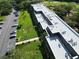 Aerial view of a multi-story building with a parking lot and mature landscaping at 36750 Us 19 N Hwy # 3104, Palm Harbor, FL 34684