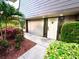 Front entrance adorned with lush landscaping, leading to a well-maintained community at 36750 Us 19 N Hwy # 3104, Palm Harbor, FL 34684