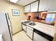 Compact kitchen with white appliances and plenty of counter space at 36750 Us 19 N Hwy # 3104, Palm Harbor, FL 34684