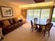 Inviting living room with a sofa, dining table, and natural light at 36750 Us 19 N Hwy # 3104, Palm Harbor, FL 34684